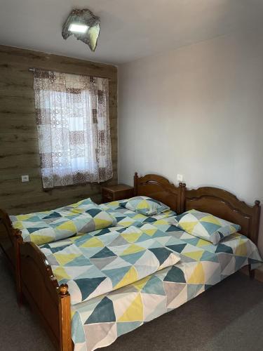 a bedroom with a bed with a colorful comforter at Armenian Camp, Sevan in Artanish