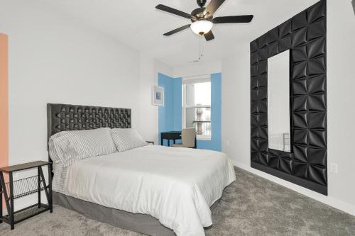 a bedroom with a bed and a ceiling fan at Contemporary 1 BDRM Apt with Pool Parking Gym in Indianapolis