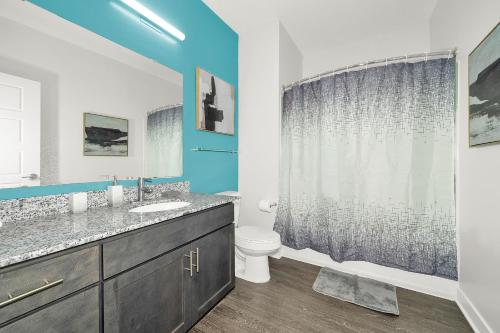 a bathroom with a sink and a toilet at Contemporary 1 BDRM Apt with Pool Parking Gym in Indianapolis