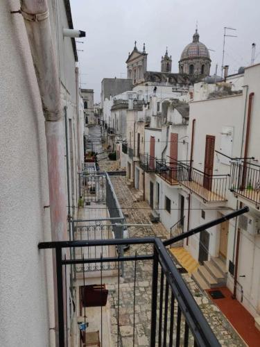 a view from a balcony of an alley between buildings at Casa Munna in Ceglie Messapica