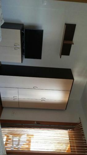 a ceiling with a flat screen tv and a window at Eros apartmani in Zlatibor