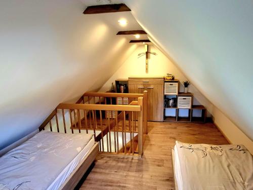 a attic room with a bed and a staircase at Ab unters Reet in Born