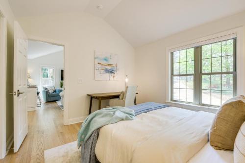 a bedroom with a bed and a desk and a window at Beautiful Raleigh Cottage Rental 5 Mi to Downtown in Raleigh