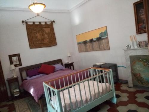 a room with a crib in a bedroom at Sweet Garden Maison de Charme in Thiesi