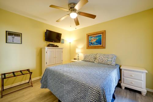 a bedroom with a bed and a ceiling fan at Oceanfront Carolina Beach Condo with Pool and Views! in Carolina Beach