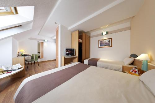 A bed or beds in a room at ibis Namur Centre