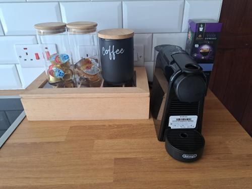a kitchen counter with a coffee maker and a box of donuts at Liakoto in Panayia