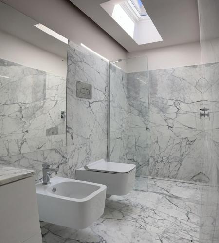 a white bathroom with a sink and a toilet at Palazzo Triolo - Dimora di Charme in Corleone