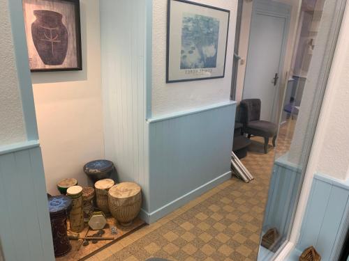 a hallway with a door and some baskets at Initial by balladins, Hôtel Restaurant Broisin in Aix-les-Bains
