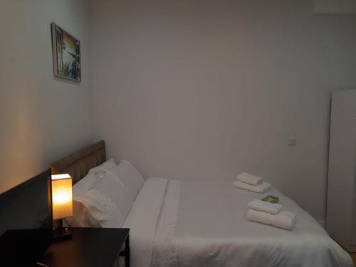 a bedroom with a bed with towels on it at Grand Bleu - London - Next to Piccadilly Line Tube Station & Brand New Facilities in London
