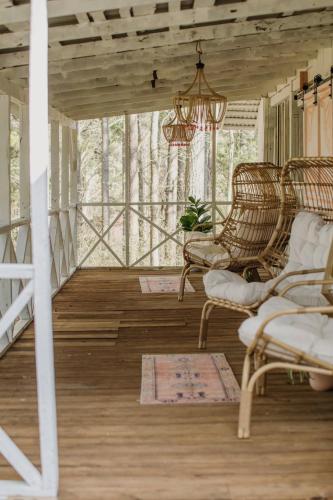 a porch with wicker chairs and a chandelier at Camp Swann in Tracy City