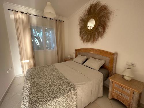 a bedroom with a bed and a mirror on the wall at La Giralda in Denia