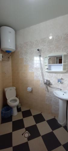a bathroom with a toilet and a sink at ВИКЕНД in Karolino-Buhaz