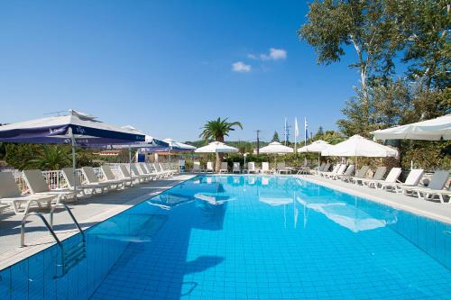a large swimming pool with chairs and umbrellas at Koukias Village in Troulos