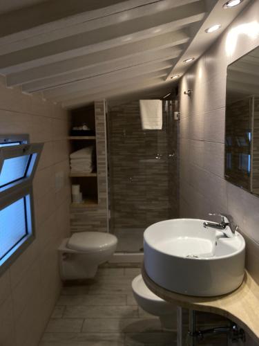 a bathroom with a sink and a toilet at Hotel Pino in Lerici