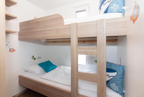 a bunk bed in a small room with a bunk bed in a bedroom at Floating House Adela in Portorož
