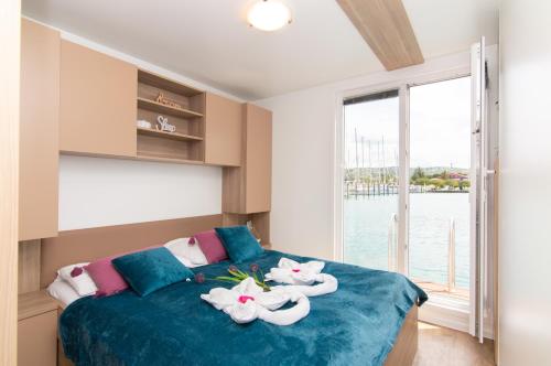 a bedroom with a bed with towels on it at Floating House Adela in Portorož