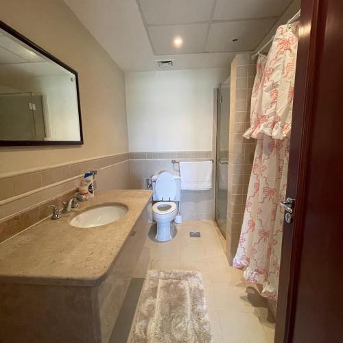a bathroom with a sink and a toilet at شقة باطلاله بحريه - أبراج الشاطئ البيلسان Seafront Apartment in King Abdullah Economic City