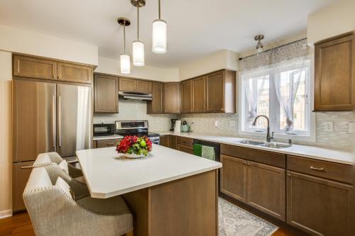 a kitchen with wooden cabinets and a table with flowers on it at Wilmington Vacation Rental Less Than 2 Mi to Downtown! in Wilmington