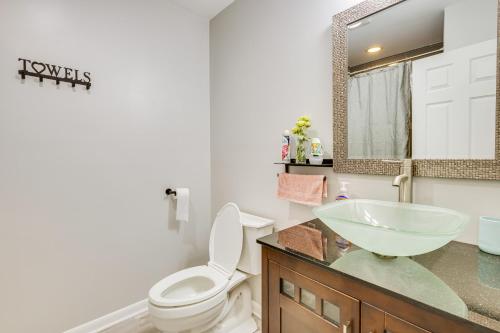 a bathroom with a sink and a toilet and a mirror at Wilmington Vacation Rental Less Than 2 Mi to Downtown! in Wilmington