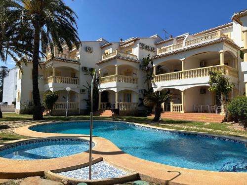 a large building with a swimming pool in front of it at La Giralda in Denia