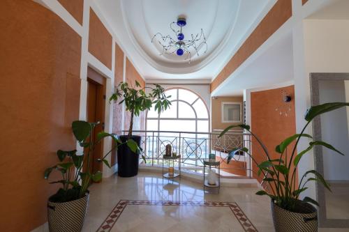 a hallway with potted plants and a chandelier at Villa The View in Villefranche-sur-Mer
