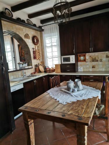 a kitchen with a wooden table in the middle at Maronia Luxury Villa in Maronia