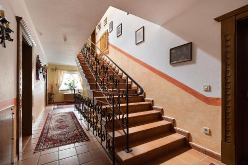 a spiral staircase in a home with a rug at Pension Glockenstuhl in Finkenberg