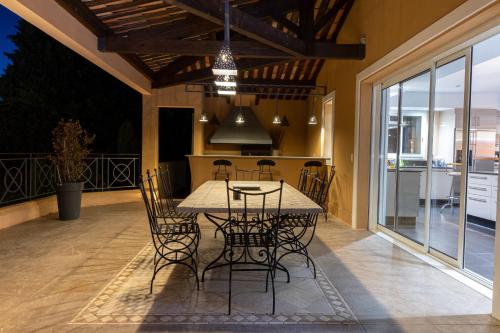 a dining area with a table and chairs on a patio at Villa The View in Villefranche-sur-Mer