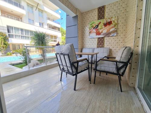 a patio with a table and chairs on a balcony at Kemer Classic Apartments in Kemer