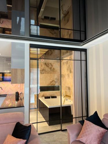 a living room with a bath tub and a couch at Golden Life in Kielce