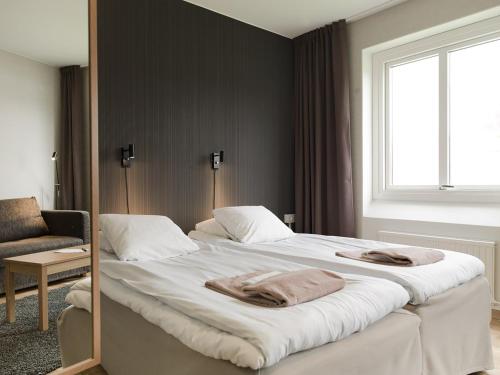 Säng eller sängar i ett rum på Hotell Svanen