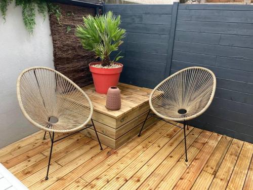 dwa krzesła i stół z doniczką na patio w obiekcie Appartement centre ville Quimper avec terrasse w mieście Quimper