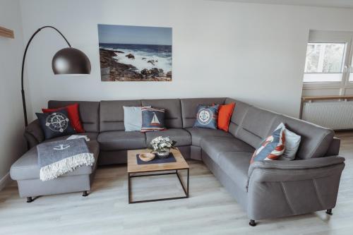 a living room with a couch and a table at Deine MEERZeit in Büsum