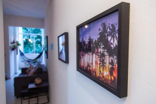 a television hanging on a wall in a living room at Vista Verde Laranjeiras in Rio de Janeiro