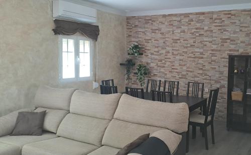 a living room with a white couch and a table at Playas, cultura y gastronomía en Casa Sarco 2 habitaciones in San Fernando