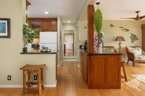 an open kitchen and living room with a counter at Hale Hahalua - Serenity and Ocean Views in Kailua-Kona at Keauhou Akahi above Keauhou Bay in Kailua-Kona