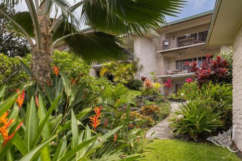 a garden in front of a building with plants at Hale Hahalua - Serenity and Ocean Views in Kailua-Kona at Keauhou Akahi above Keauhou Bay in Kailua-Kona