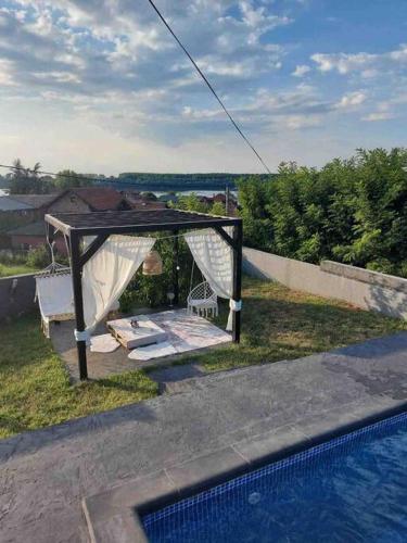 a gazebo by a swimming pool next to at Vila Sunset Jugovo in Udovice