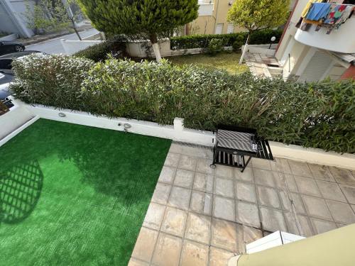 an overhead view of a green yard with two benches at Bella Maisonette in Pefkohori