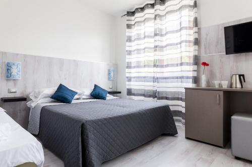 Ένα ή περισσότερα κρεβάτια σε δωμάτιο στο Hotel Canarino