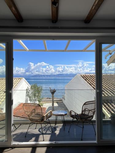 a view of the ocean from the balcony of a house at Greco Mare in Kavos