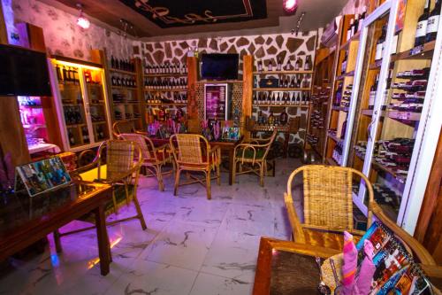 a restaurant with chairs and a table in a room at Deep Forest Garden Hotel in Puerto Princesa City