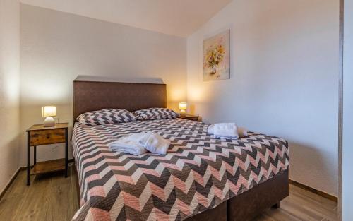 a bedroom with a bed with two towels on it at Villa Asta Medulin in Medulin