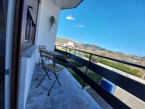 a balcony with a table and a view of the ocean at piso el puntual 1 in Arriondas