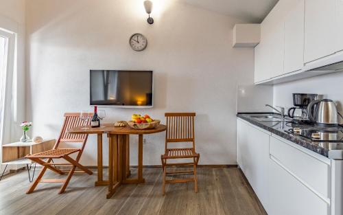 a kitchen with a table with a bowl of fruit on it at Villa Asta Medulin in Medulin
