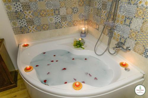 a bath tub filled with candles and red votives at Il Borgo in Subiaco