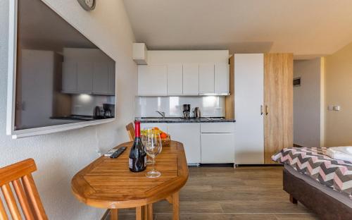 a kitchen with a wooden table with wine glasses on it at Villa Asta Medulin in Medulin