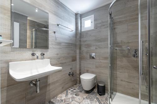 a bathroom with a sink and a toilet and a shower at Spiros in Naxos Chora