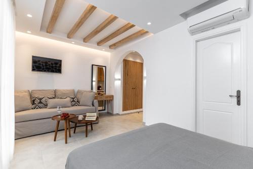 a living room with a couch and a bed at Spiros in Naxos Chora